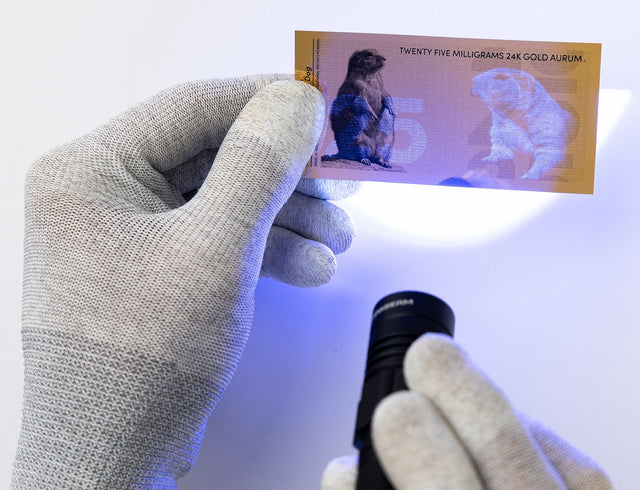 25 milligram 24k gold bill shown with uv security features under black light