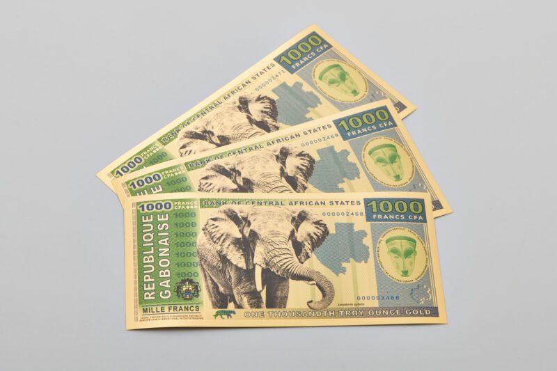 A fan of three of the Gabon 1000 Franc Aurum® Gold Bill