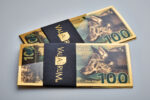 2 stacks of 100mg North American Gray Wolf Aurum® Gold Bills in a Valaurum belly-band.